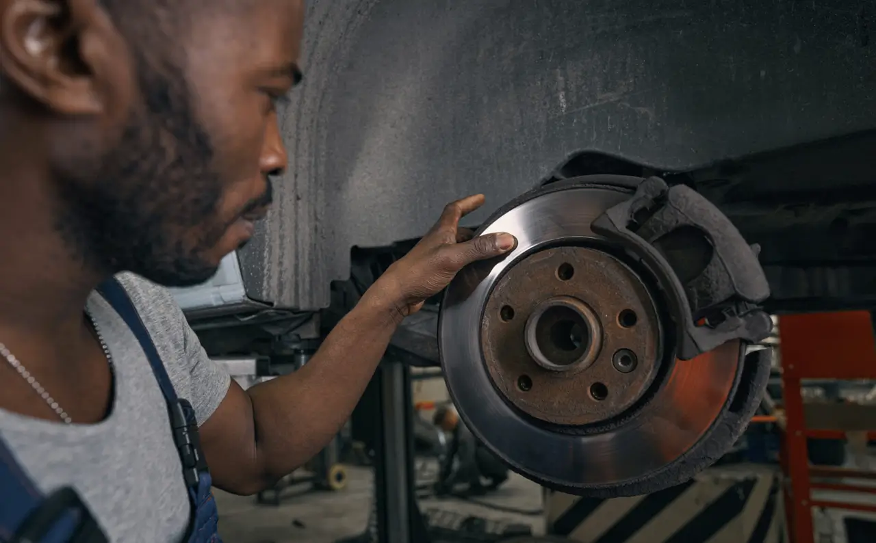 Service - Mechanic Checking Brakes - Feature Image